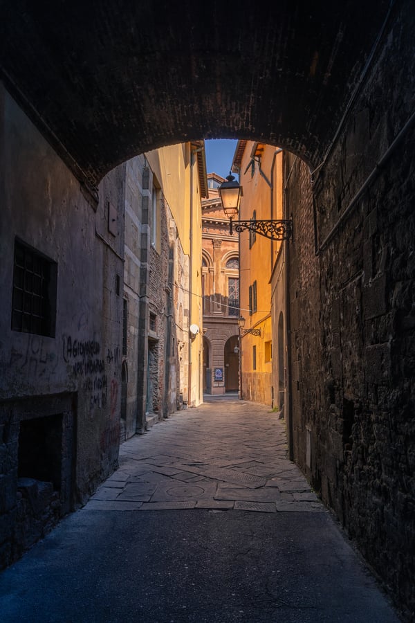 vieja-calle-medieval-oscura-estrecha-vacia-edificios-coloridos-puntos-luz-solar-florencia-italia